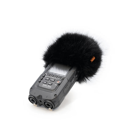 Gray handheld recorder with black furry windscreen