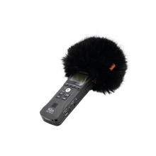 Handheld audio recorder with large black furry windscreen