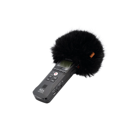 Handheld audio recorder with large black furry windscreen