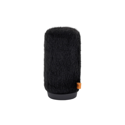 Hair brush attachment with dark bristles, gray base edge, visible orange label