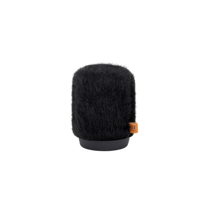 Black furry microphone windscreen cylinder with orange bottom label