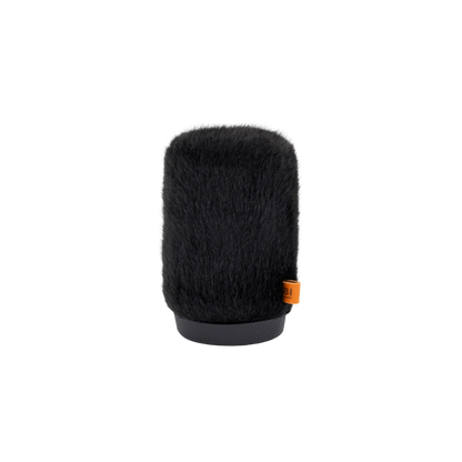 Black cylindrical furry microphone windscreen with small orange label